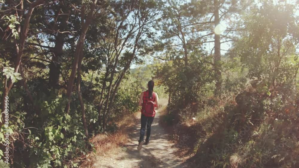 Young Woman Walking In Tight Mountain Forest Path Between Bushes Hiking In Sunny Warm Hot Day Holding Bottled Water Beautiful Nature Landscape With Sun Flares Young Woman Walking In Tight Mountain Forest Path Between Bushes Hiking In Sunny Warm Hot Day Holding Bottled Water Beautiful Nature Landscape With Sun Flares