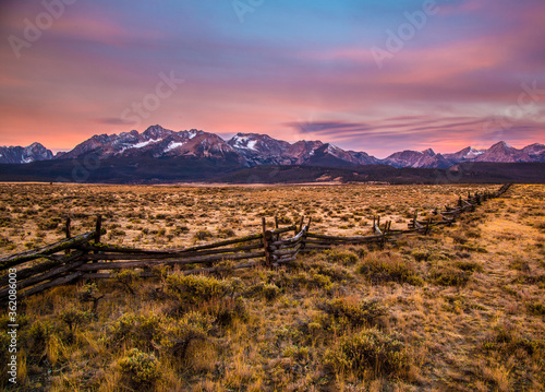 A split rail fence and the Sawtooth mountains at sunrise near Stanley  Idaho.