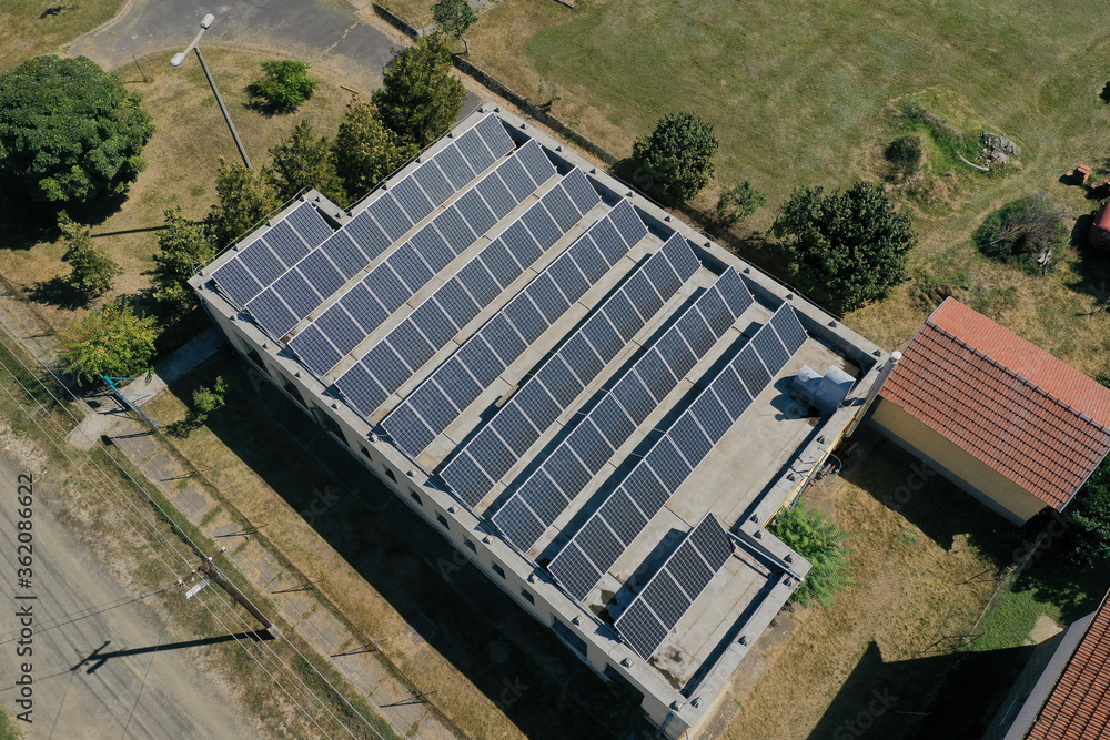 Solar panels on the roof for electricity generation. aerial view with drone. Renewable ecological green energy production concept.