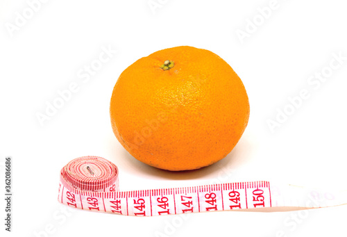 Orange fruit and tailors centimeter on white background. Cellulite fight and slimming diet conceptual photo.