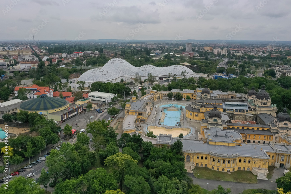 The Szechenyi Spa is one of the largest spa complexes in Europe in the Budapest City Park. In the background is the capital's Great Circus, and the capital's Zoo - Budapest - Hungary / June.11.2020.