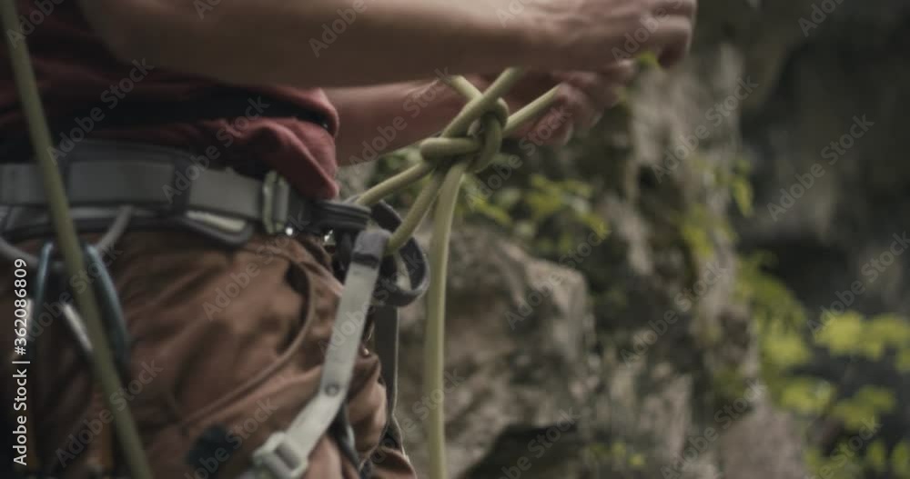Video Stock Climber detach unfasten untie and loosen belay knot rope on ...