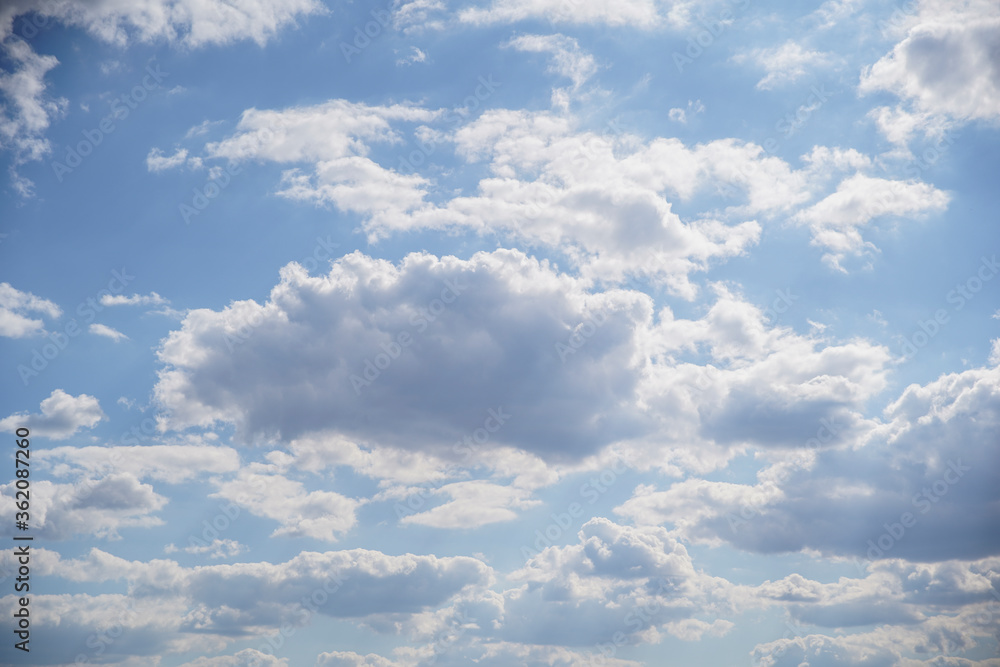 Fototapeta premium Blue sky on a sunny day with fluffy white clouds. Nature background.