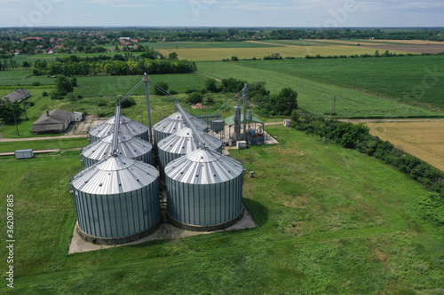 Agricultural silos on a farm, photos from above with a drone. Industrial agricultural granary, processing plant, elevator dryer, storage and drying of cereals, wheat, corn, soybeans, sunflowers.
