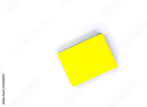 New yellow sponge for dish or car washing. Cleaning sponge top view photo on white background. Janitor or maid tool. Simple kitchen cleaning rub. Housekeeping chores banner template with text place