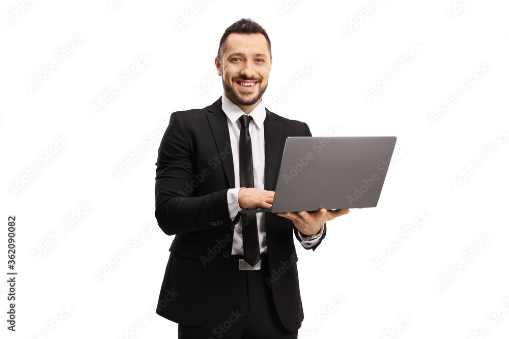 Businessman working on a laptop computer and smiling at the camera
