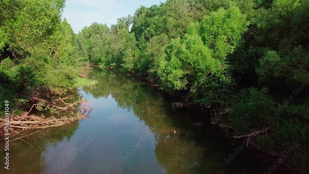 Flight over the River forest at sunset. Summer landscape of nature of Russia. With Tree trunks growing on banks. Moscow Region, Istra River. Fly drone Flight over the River forest at sunset. Summer landscape of nature of Russia. With Tree trunks growing on banks. Moscow Region, Istra River. Fly drone