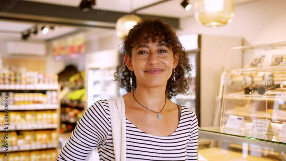 Happy Customer Standing in a Shop and Smiling in the Camera. Going Grocery Shopping with a very Calm Atmosphere. Happy Customer Standing in a Shop and Smiling in the Camera. Going Grocery Shopping with a very Calm Atmosphere.