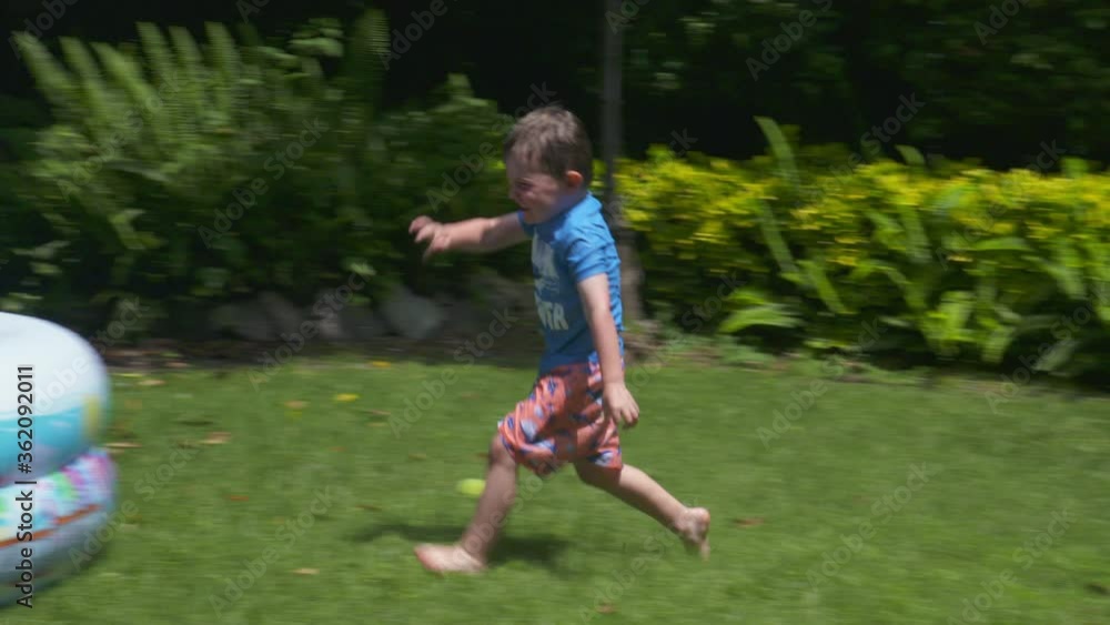Little kids run, play and splash in a backyard inflatable pool Little kids run, play and splash in a backyard inflatable pool