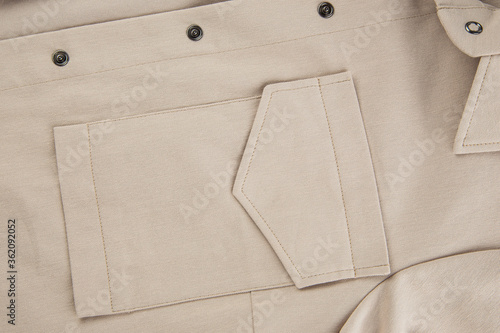 patch pocket with flap on a beige shirt made of thick cotton fabric