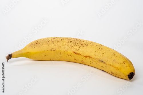 Single yellow banana isolated on a white background
