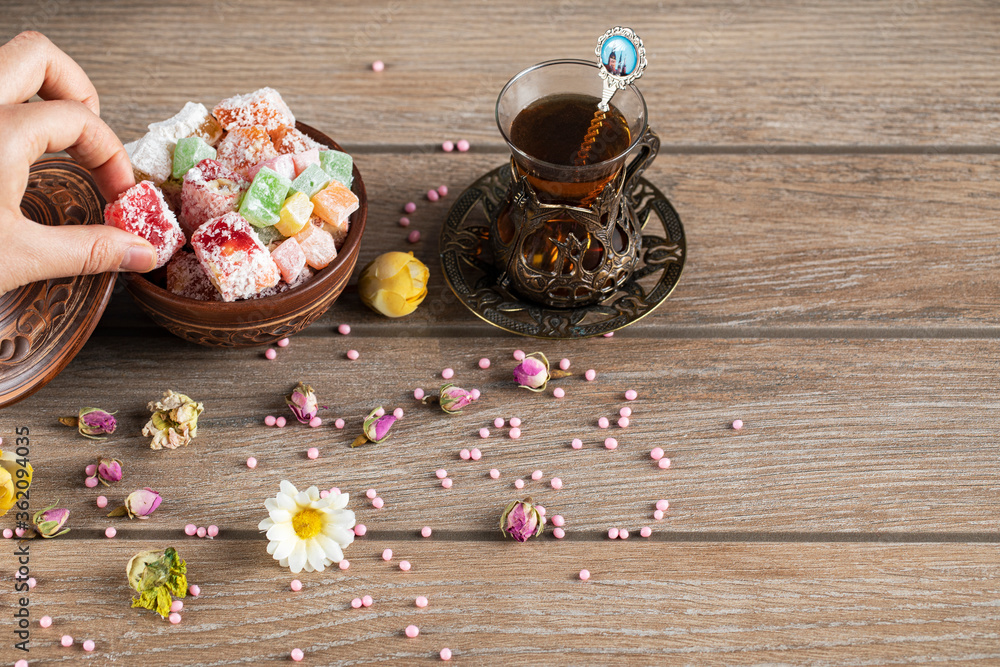 Having lokum candies with a glass of tea Having lokum candies with a glass of tea
