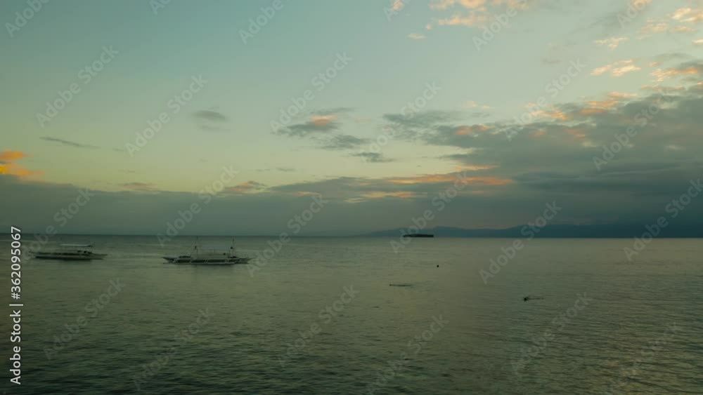 Colorful bright clouds during sunset over the sea, aerial view. Sunset over ocean. Seascape, Summer and travel vacation concept, Moalboal, Philippines. Colorful bright clouds during sunset over the sea, aerial view. Sunset over ocean. Seascape, Summer and travel vacation concept, Moalboal, Philippines.