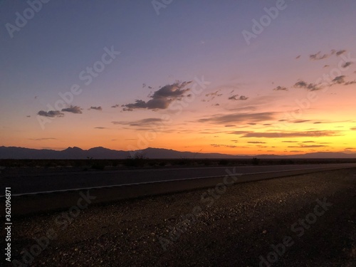 sunset and mountains on highway