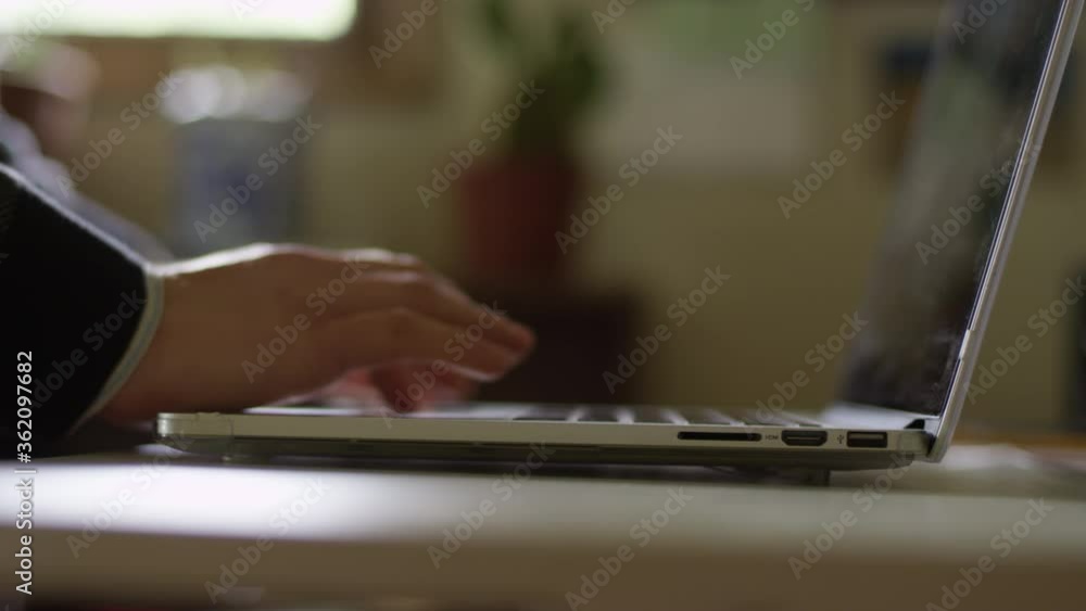 Close up of hands opening up a laptop and starting to type Close up of hands opening up a laptop and starting to type