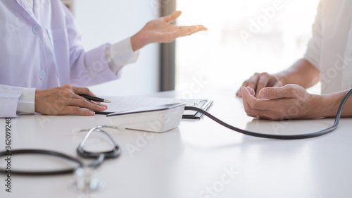 doctor giving consulting and diagnostic to patient and explaining medical information prevention disease