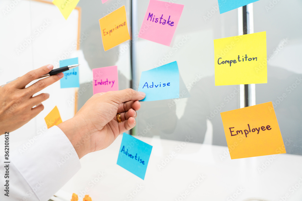 business team planning startup project placing sticky notes session to share idea or brainstorm business team planning startup project placing sticky notes session to share idea or brainstorm