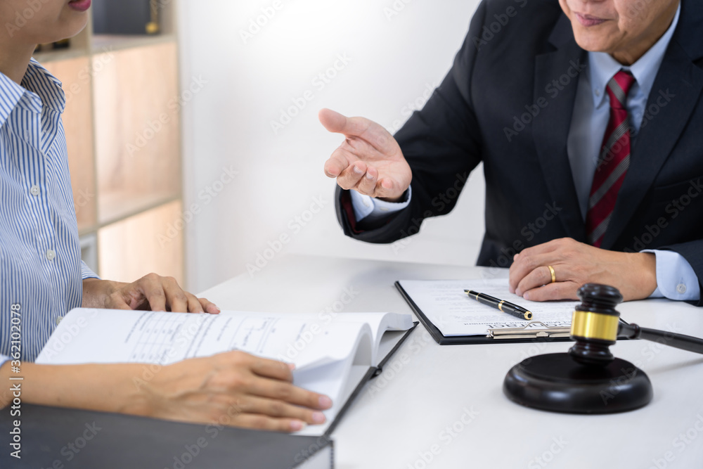 Client with his partner lawyers or attorneys discussing discussing a document or contract agreement Client with his partner lawyers or attorneys discussing discussing a document or contract agreement