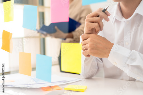 business team planning startup project placing sticky notes session to share idea or brainstorm