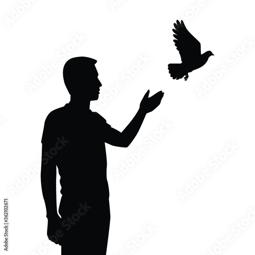 Young man releases a bird to freedom silhouette vector