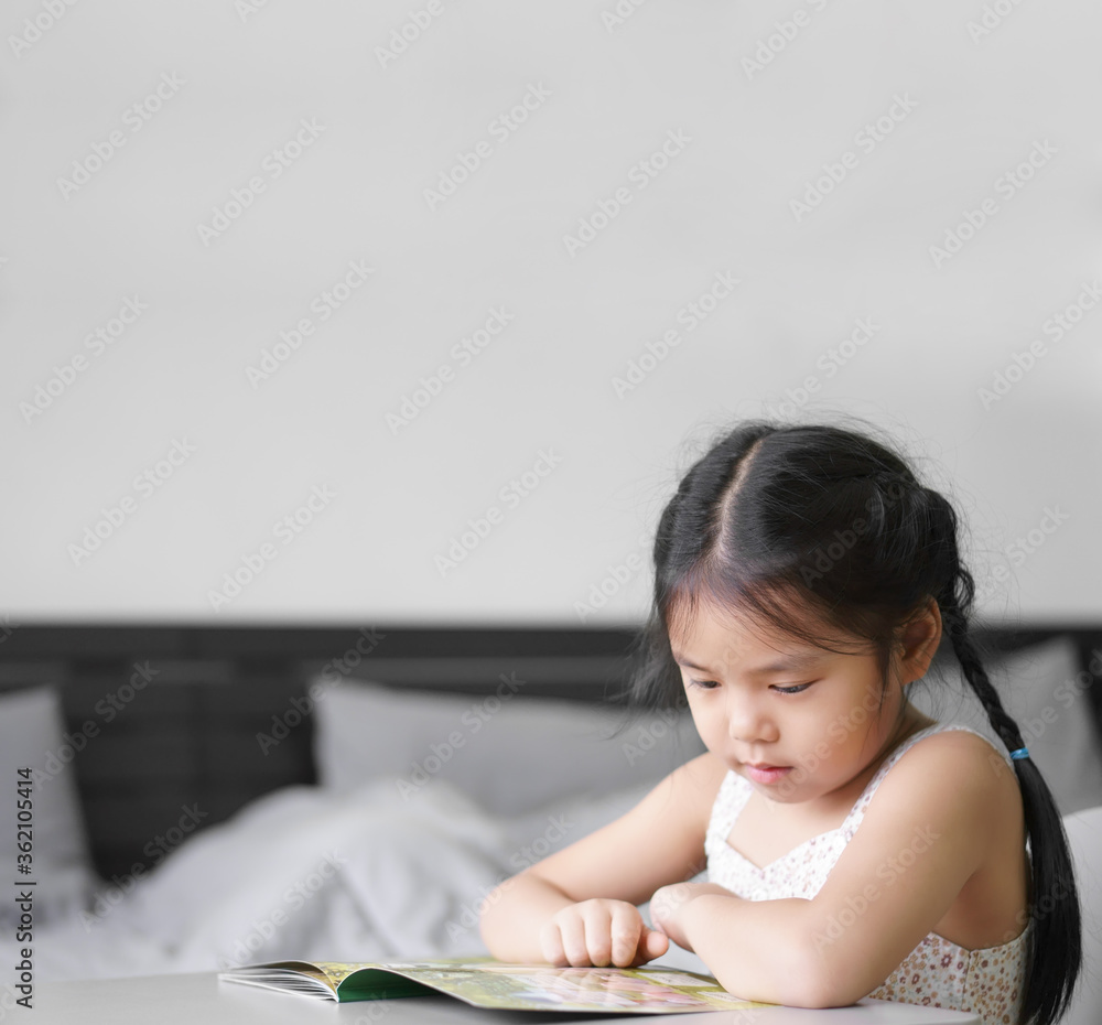 asian child cute or kid girl happy and student enjoy reading story book or cartoon and smile by learn from home to read study with education on table in bedroom or nursery kindergarten back to school asian child cute or kid girl happy and student enjoy reading story book or cartoon and smile by learn from home to read study with education on table in bedroom or nursery kindergarten back to school