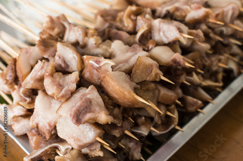 Skewered Pork ears ready to be cooked on the grill. photo