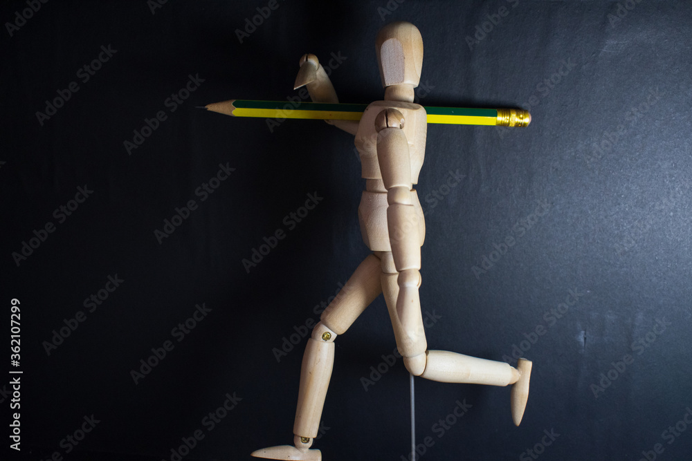 wooden mannequin with a pencil running in the dark wooden mannequin with a pencil running in the dark