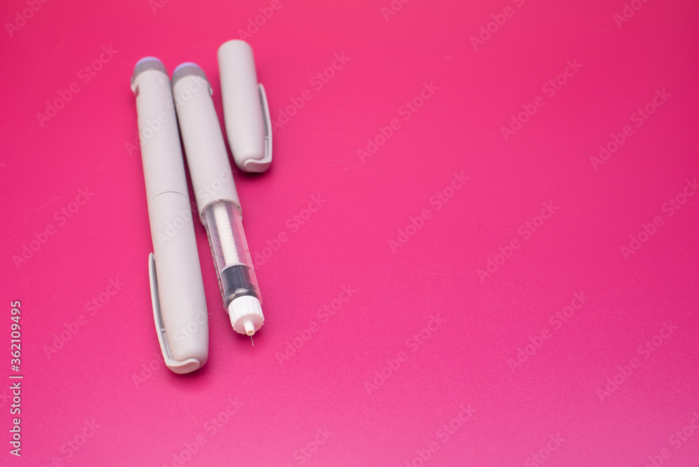 Insulin pen and cartridge over red background Insulin pen and cartridge over red background