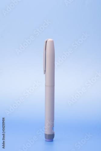 Insulin pen isolated over blue background