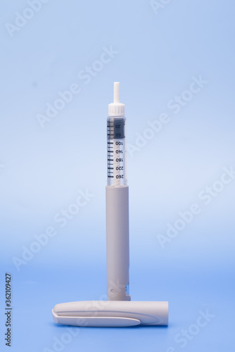 Insulin pen isolated over blue background