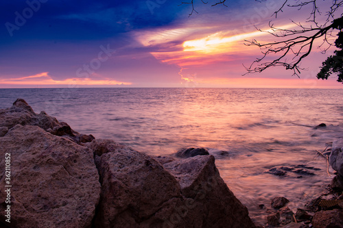 beautiful beach in the evening. Sunset over sea. Pictures in clude sea, rocks, trees, sky, clouds and lighsun. photo