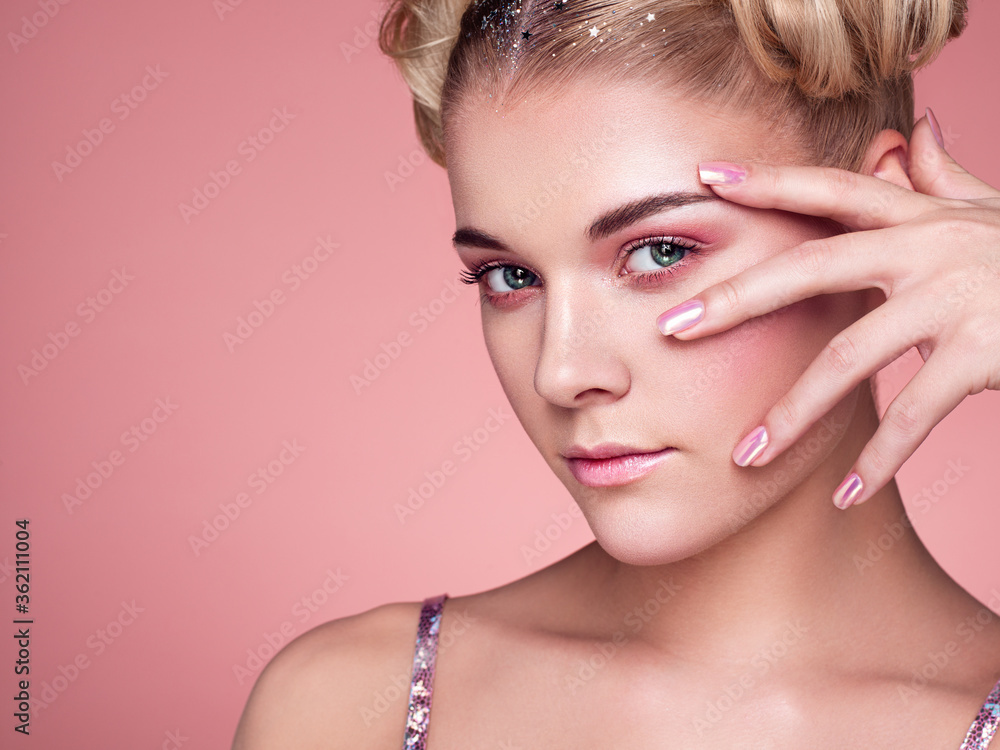 Naklejka premium Blonde Girl with Elegant and shiny Hairstyle. Beautiful Model Woman with Curly Hairstyle. Care and Beauty Hair products. Nails and Manicure. Hair Curled into a Bun