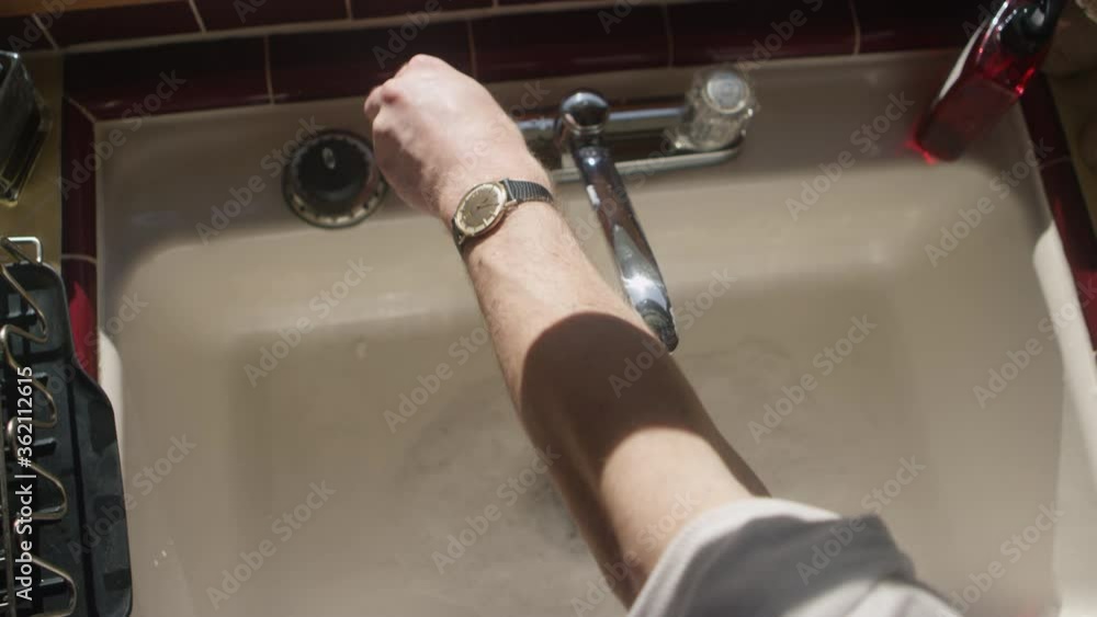 Hands turning on a sink and washing hands with soap Hands turning on a sink and washing hands with soap