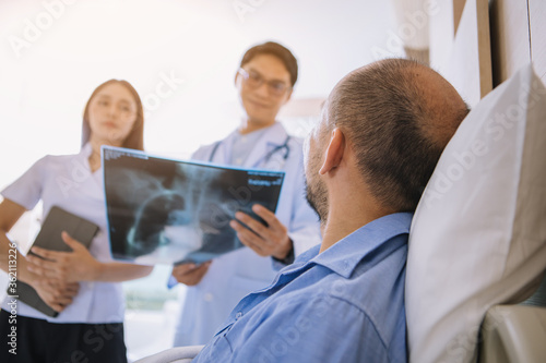 Doctor having health problem of patient at hospital,medicine, doctor, healthcare and people concept