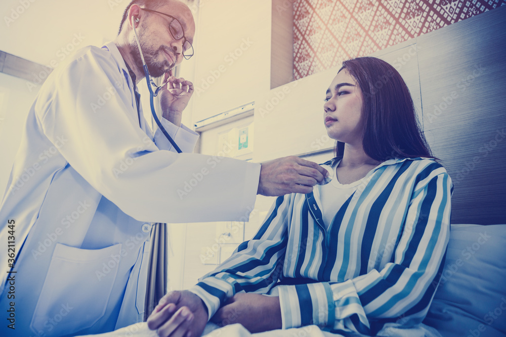 Doctor having health problem of patient at hospital,medicine, doctor, healthcare and people concept Doctor having health problem of patient at hospital,medicine, doctor, healthcare and people concept