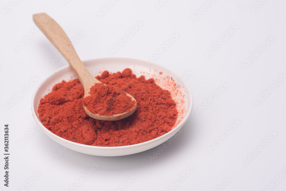 Chili powder isolated over grey background Chili powder isolated over grey background