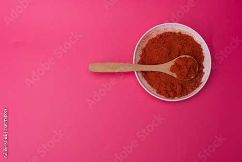 Chili powder over red background