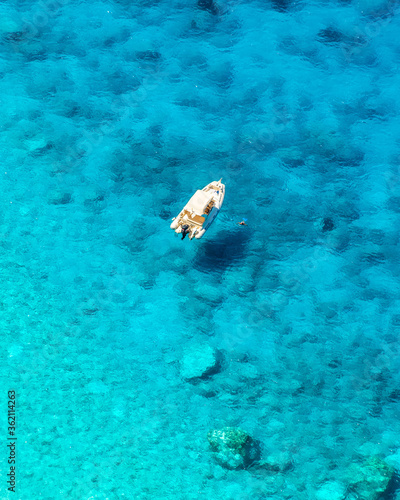 a boat anchored at Porto Katsiki beach on the island of Lefkada!