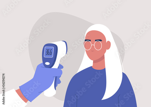 Covid-19 prevention, a hand holding a body Medical Infrared Thermometer, a young female patient