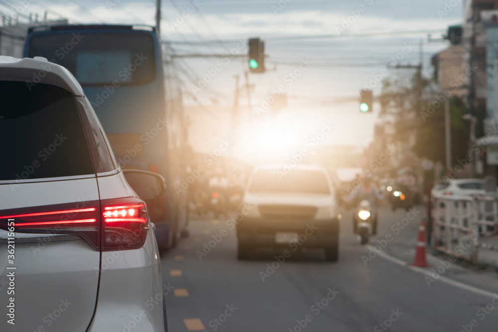 Transportation of white car on the road. Open light break waiting to release traffic signals. On the asphalt road. Many cars prepare to travel when the green traffic signs.
