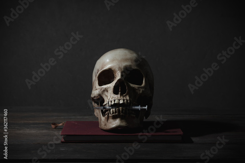 Still life of human skull that died for a long times ,concept of Drug concept and horror or thriller movies of scary crime scene ,Halloween theme, visual art