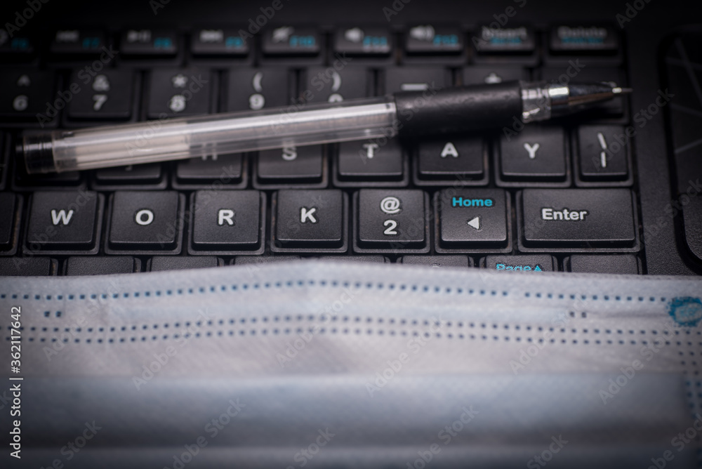 A pen on top of a keyboard with the phrase work at home A pen on top of a keyboard with the phrase work at home
