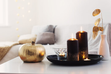 home decor with golden pumpkin and burning candles