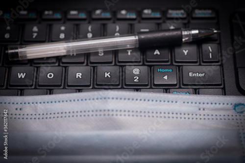 A pen on top of a keyboard with the phrase work at home