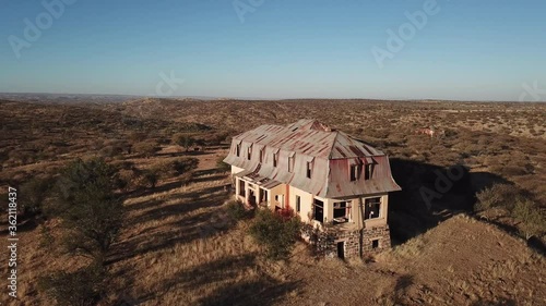 4K aerial drone video of Africa savanna hills, plains and abandoned dilapidated old colonial mansion west of Windhoek in central highland Khomas Hochland of Namibia, southern Africa photo