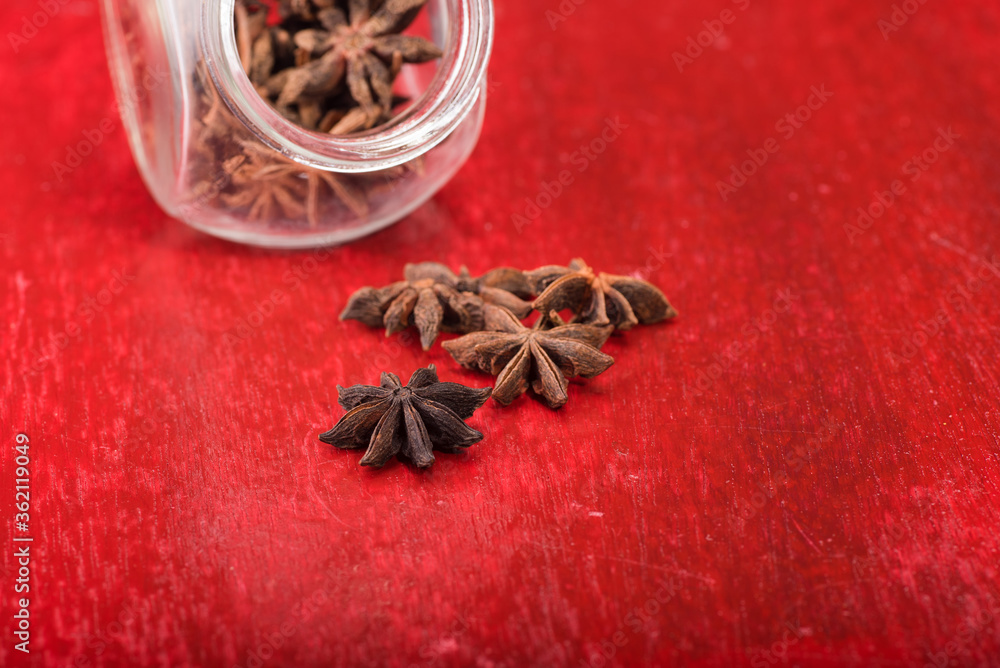 Star anise over red wooden background Star anise over red wooden background
