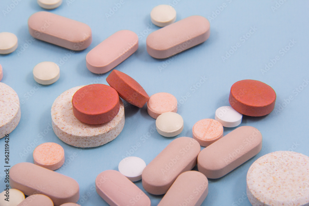 Pills and colored capsules out of the package. Color tablets and capsules from the wing view. Pills and colored capsules out of the package. Color tablets and capsules from the wing view.