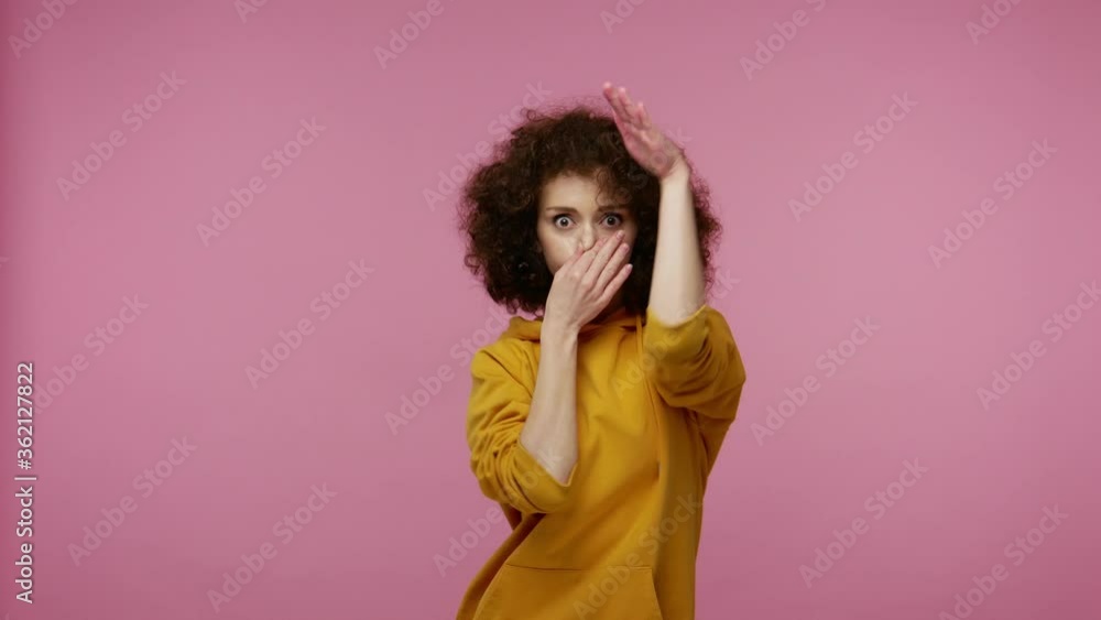 Lively vivid girl afro hairstyle in hoodie enjoying party music, moving in energetic dance, feeling carefree happy inspired, celebrating success. indoor studio shot isolated on pink background Lively vivid girl afro hairstyle in hoodie enjoying party music, moving in energetic dance, feeling carefree happy inspired, celebrating success. indoor studio shot isolated on pink background
