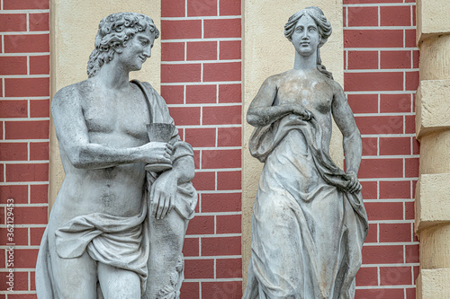 Ancient statues of dating woman and man of Roman Era in the historical downtown in Potsdam, Germany