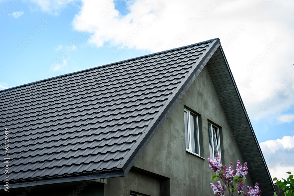 Construction of the roof of the house. Metal tiles.